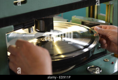 Diepholz, Germany. 09th Aug, 2012. Karl-Heinz Brandt prepares a record blank to punch the hole at the record factory Pallas in Diepholz, Germany, 09 August 2012. Photo: Carmen Jaspersen/dpa/Alamy Live News Stock Photo