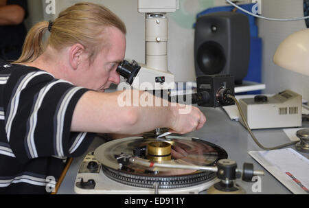 Diepholz, Germany. 09th Aug, 2012. Udo Karduck removes dust from a template during the quality control in the acoustics room of the record factory Pallas in Diepholz, Germany, 09 August 2012. Photo: Carmen Jaspersen/dpa/Alamy Live News Stock Photo