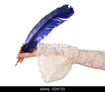 Female hand in antique sleeve writing with a quill feather Stock Photo