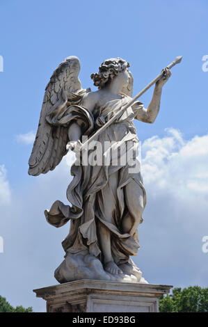 An Angel sculpture against a blue sky holding a lance from St Angelo bridge in City of Rome, Italy. Stock Photo