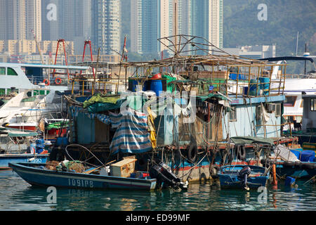 Crowded bay. Collection of assorted boats crammed into a small space. The main vessel is covered in all sorts of objects Stock Photo