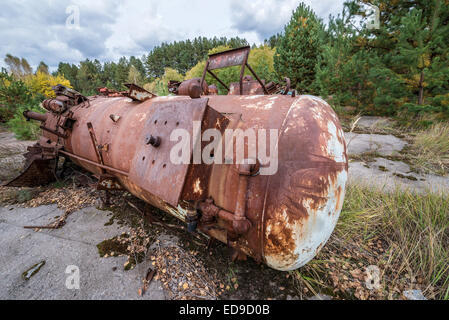 rusty cistern on junk yard near Illinci village in Chernobyl Nuclear Power Plant Zone of Alienation, Ukraine Stock Photo