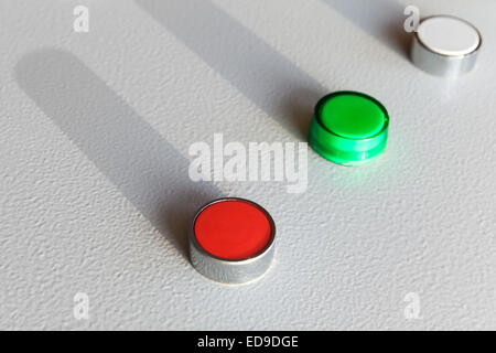 Three industrial buttons on gray steel control panel Stock Photo