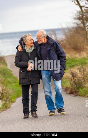 happy mature couple relaxing baltic sea dunes in autumn Stock Photo