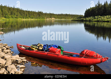 Taiga river Paga, Russia, the Polar Urals. Virgin Komi forests, red boat on the river. Stock Photo