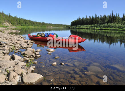 Taiga river Paga, Russia, the Polar Urals. Virgin Komi forests, red boat on the river. Stock Photo