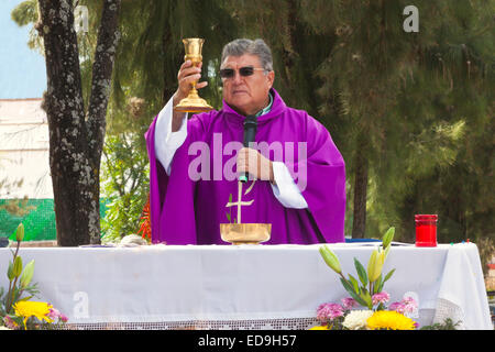 A PRIEST preforms a service in the graveyard during DAY OF THE DEAD -  SAN MIGUEL DE ALLENDE, MEXICO Stock Photo