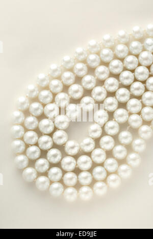 Pearl necklace in closeup on paper background Stock Photo