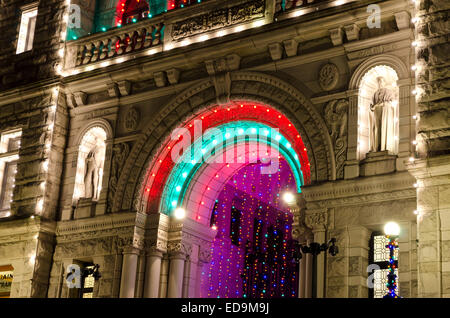 Colourful Christmas lights at the entrance to the British Columbia provincial parliament buildings at night. Government building Stock Photo