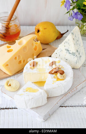 Assorted cheese on a cutting board, tasty food Stock Photo