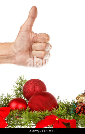 decorative red ornaments with pine or fir  for Christmas or New Year tree witrh human thumb up, Holidays time isolated on white Stock Photo