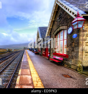 The railway station at Ribblehead which is on part of the famous Settle to Carlisle line. Ribbleshead is in the Yorkshire Dales  Stock Photo