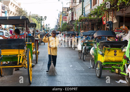 Street sweeper and horse carts on Jalan Malioboro, one of the main avenues in Yogyakarta, Java, Indonesia. Stock Photo