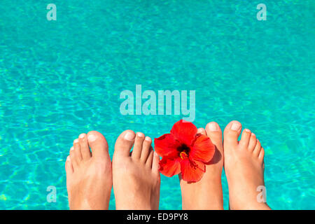 macro picture the newlyweds feet by the pool with flower Stock Photo