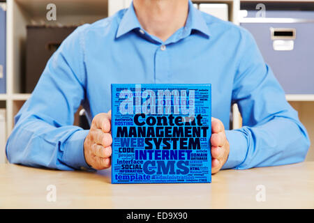 Hands holding Content Management System concept on a blue box Stock Photo