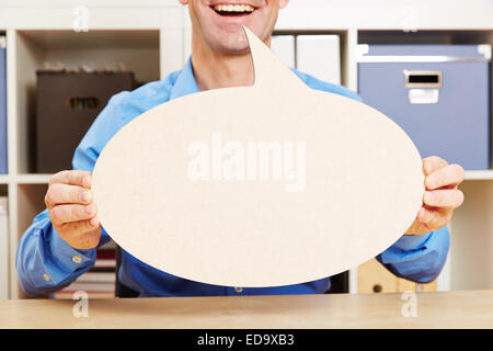 Man talking with big empty speech bubble in his office Stock Photo