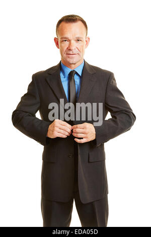 Business man buttoning up his suit buttons with his fingers Stock Photo