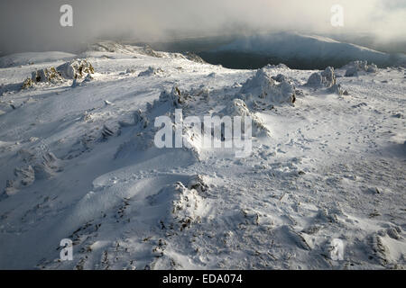 Rocks formations atop a snowy Glyder Fawr. Glyder Fawr, Snowdonia National Park, Wales, UK Stock Photo