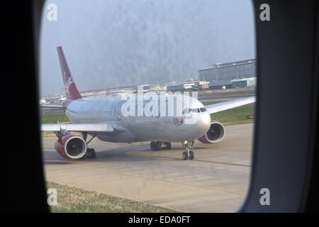 a Virgin Atlantic aircraft taxiing to line up on the runway at Gatwick Airport Stock Photo