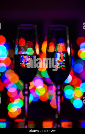 An abstract image of wine glasses in front of Christmas lights Stock Photo