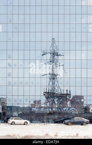 electric pole reflected in windows of office building Stock Photo