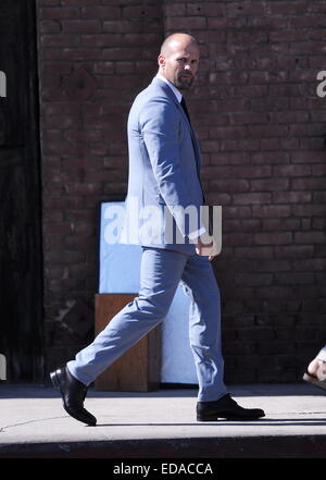 Actor Jason Statham puts on a gray suit at a photoshoot in downtown L.A for French GQ magazine with famous photgrapher Jeff Lipsky.  Featuring: Jason Statham Where: Los Angeles, California, United States When: 01 Jul 2014 Stock Photo