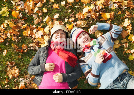 teenagers lying on ground Stock Photo