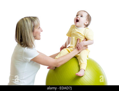 child and mother doing yoga with fitness ball Stock Photo