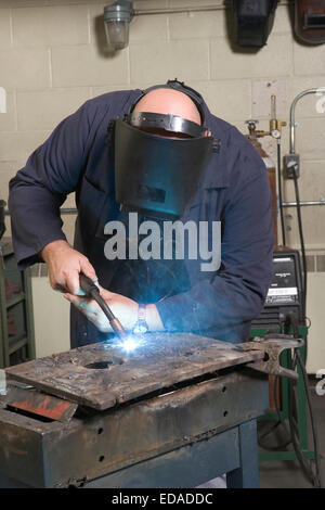 Man working in a welding shop Stock Photo