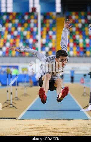 ISTANBUL, TURKEY - DECEMBER 27, 2014: Athlete Egehan Karabulut triple jump during Athletics record attempt races in Asli Cakir A Stock Photo