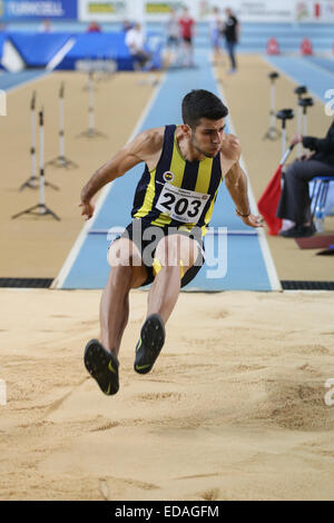 ISTANBUL, TURKEY - DECEMBER 27, 2014: Athlete Seyhmus Yigitalp triple jump during Athletics record attempt races in Asli Cakir A Stock Photo