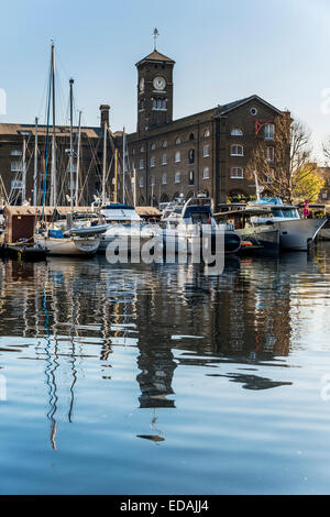 The clock tower at St Katharine docks, a once commercial dock serving London but now converted to luxury residential and leisure Stock Photo