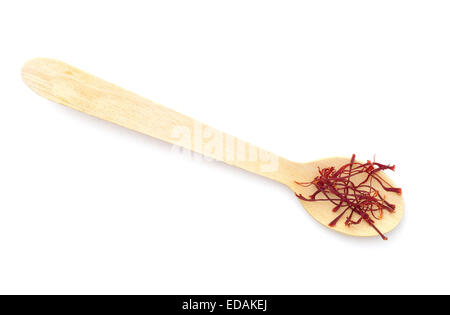 Red saffron strands on small wooden spoon. Over white. Stock Photo
