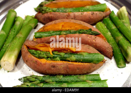 Steamed sweet potato and asparagus spears, London Stock Photo