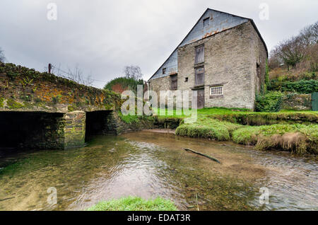 An old abandoned mill on the banks of the river Fowey at Penpol Creek in Cornwall Stock Photo