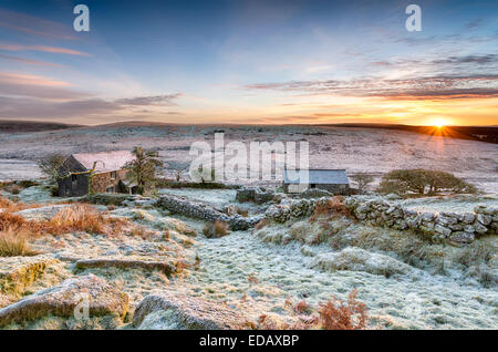 A beautiful frosty winter sunrise over an old abandoned farm at Garrow Tor on Bodmin Moor in Cornwall Stock Photo