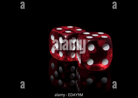 Two red casino dice on the black background Stock Photo