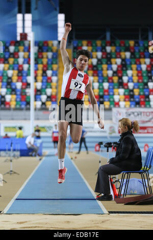 ISTANBUL, TURKEY - DECEMBER 27, 2014: Athlete Alper Kaan Yasin triple jump during Athletics record attempt races in Asli Cakir A Stock Photo