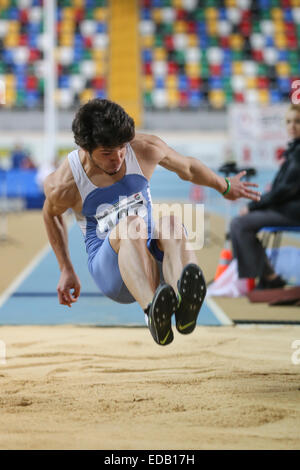 ISTANBUL, TURKEY - DECEMBER 27, 2014: Athlete Emre Dalkiran triple jump during Athletics record attempt races in Asli Cakir Alpt Stock Photo