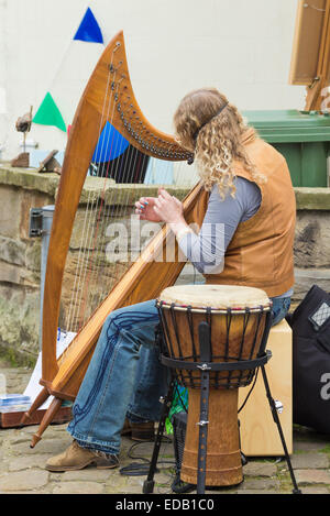 Woman playing Harp in street during Staithes Festival of Arts & Heritage Stock Photo