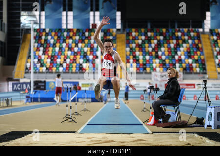 ISTANBUL, TURKEY - DECEMBER 27, 2014: Athlete Sinan Bircan triple jump during Athletics record attempt races in Asli Cakir Alpte Stock Photo