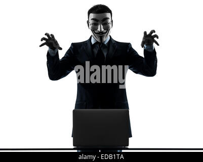 Paris, France - October 30, 2012 : one man dressed and masked as a member of Anonymous underground group member computing computer on October 30, 2012 in Paris ,France Stock Photo