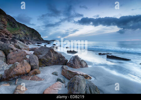 Cloudy dawn at Pentewan Sands on the Cornwall coast near Mevagissey Stock Photo