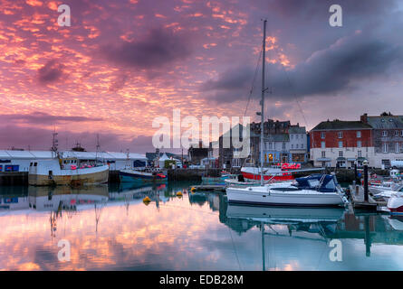 Fiery sunrise over Padstow harbour on the north Cornwall coast Stock Photo