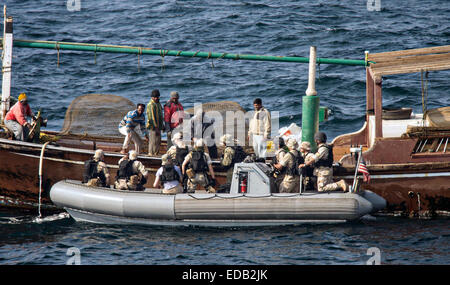 A US Navy commandos with a Visit, board, search and seizure team talk with fisherman during approach, assist and visit operations during operations December 28, 2014 in the Arabian Gulf. Stock Photo