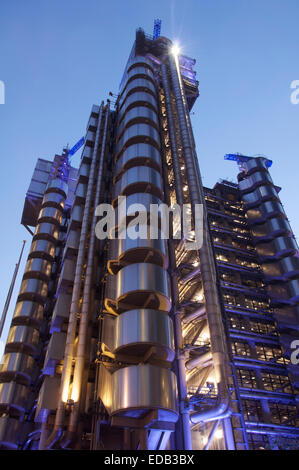 Modern architecture. The iconic Lloyd’s Building designed by Richard Rogers, home of the insurance institution Lloyds of London, illuminated by night. Stock Photo