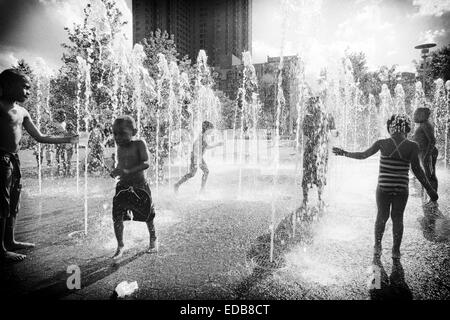 Kids Playing in a Fountain on a Hot Summer Day, Baltimore, Inner Harbor, Maryland, USA Stock Photo
