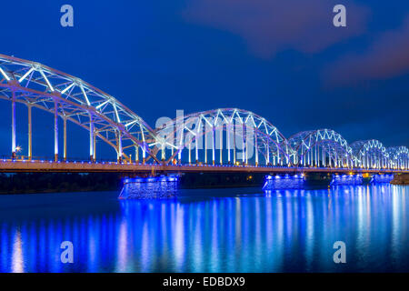 Railway bridge, Dzelzceļa tilts, at dusk, blue hour, over the Daugava river or Western Dvina, Riga, Latvia Stock Photo