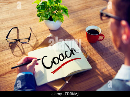 Man with a Note and a Single Word Coach Stock Photo