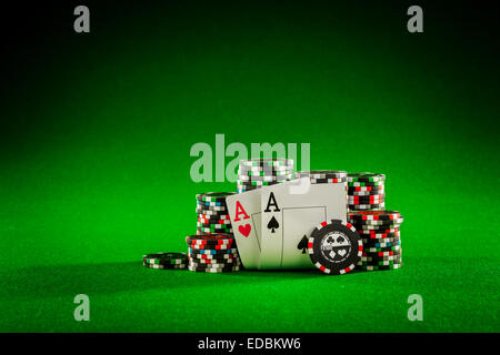 Stack of chips and two aces on the table on the green baize - poker game concept Stock Photo
